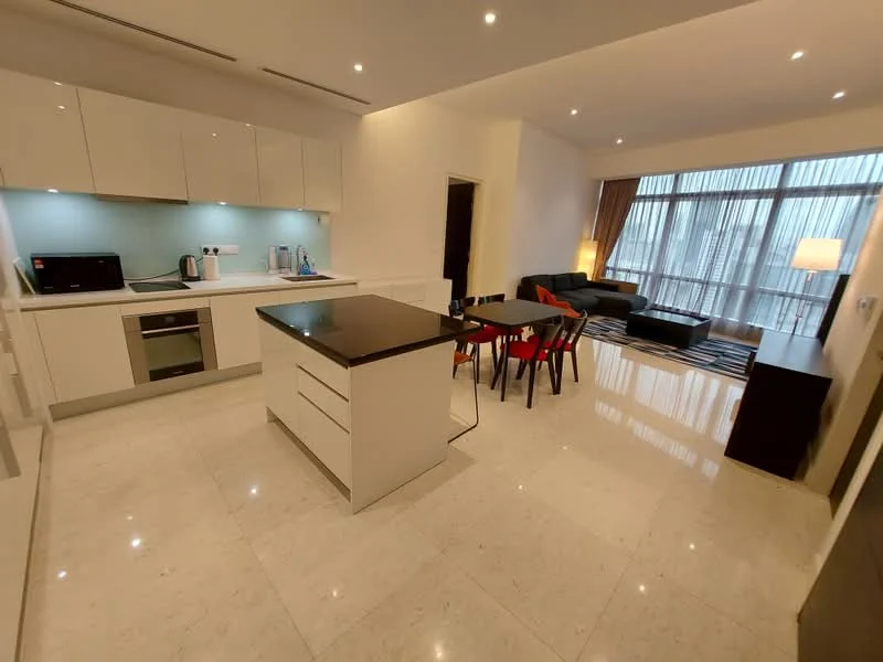 Kitchen features: white cabinetry, black granite countertop, stainless-steel sink, chrome pull-down faucet, built-in oven, freestanding range oven, microwave, refrigerator, pendant lighting, marble tile flooring, open-plan layout, island with seating, backlit backsplash; style: modern. Living features: 3-seater fabric sofa in grey, coffee table, area rug with geometric pattern, floor-to-ceiling windows, curtains, TV console, wall-mounted TV; style: modern.