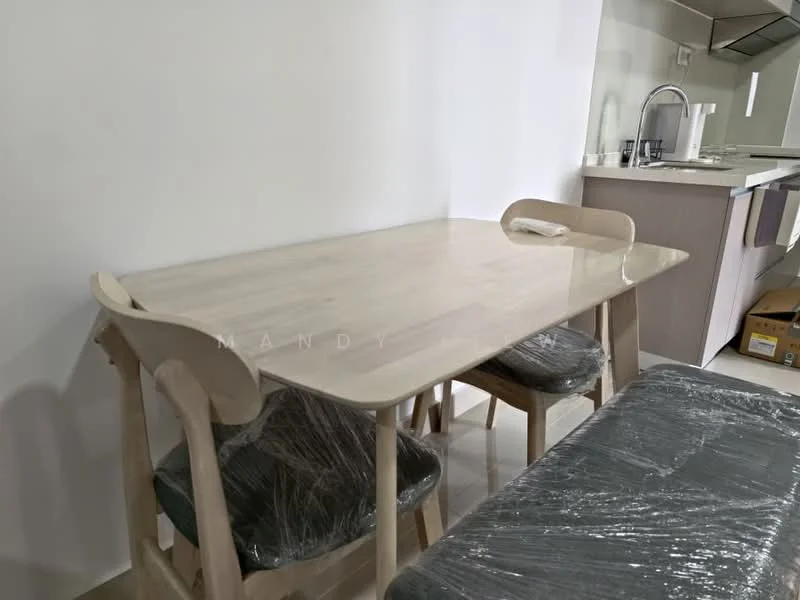 Dining features: rectangular dining table with light wood finish, 4 dining chairs with light wood frames, upholstered seats in dark fabric, plastic wrap on chairs, neutral wall color, open kitchen view in background, flooring in light tile, minimalist decor; style: modern.