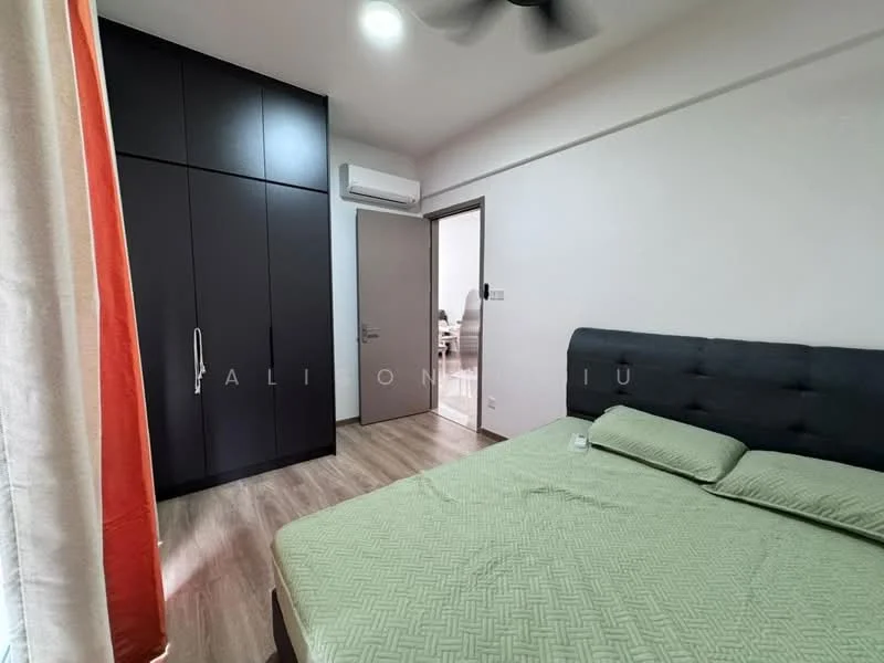 Bedroom features: queen-size bed with green bedding, upholstered headboard, black built-in wardrobe with sliding doors, wooden flooring, 1 wall-mounted split AC, ceiling fan, natural light from window, curtains in orange and white, decorative wall, nightstand with glass, doorway leading to another room; style: modern.