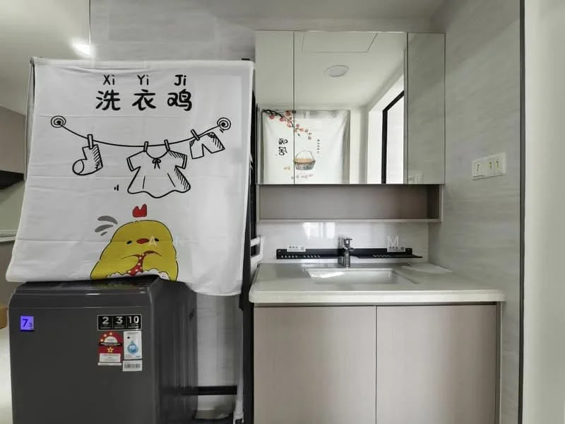 Kitchen features: stainless-steel fridge, white countertop, built-in sink, single-bowl sink, chrome faucet, light wood cabinetry, mirror above countertop, wall-mounted cabinets, grey tiled backsplash, kitchen utensils hanging, decorative wall art; style: modern.