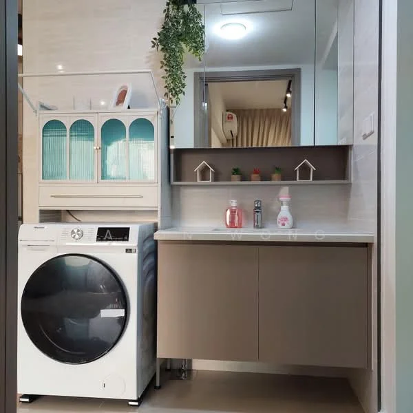 Laundry features: front-load washing machine in white, light brown cabinetry with flat-panel doors, white countertop, mirror above countertop, decorative plant hanging, glass-front upper cabinet with turquoise doors, shelf above washing machine, wall-mounted light fixture; style: modern.