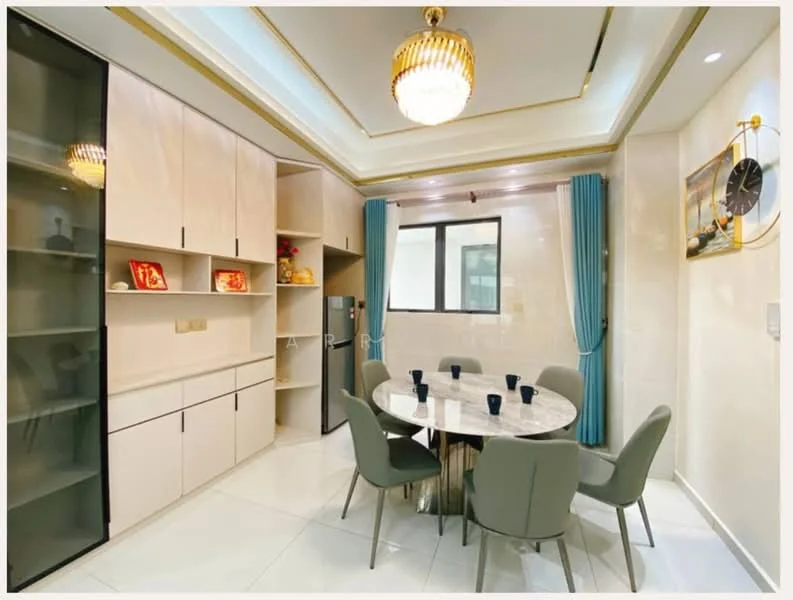 Dining features: round marble dining table, 6 upholstered dining chairs in grey, white painted walls, recessed ceiling with crown moulding, chandelier light fixture, floor-to-ceiling windows, light blue curtains, built-in cabinetry with glass doors, stainless-steel fridge, decorative wall clock; style: modern.
