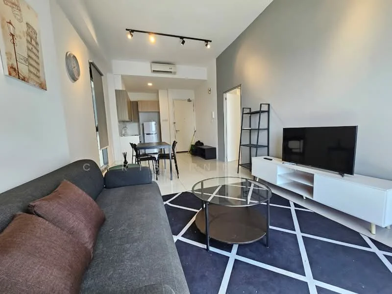 Living features: grey fabric sofa, 2 brown cushions, glass coffee table, black area rug with geometric pattern, wall-mounted TV, white TV console, track lighting, wall clock, floor-to-ceiling window, white walls, grey accent wall, air conditioning unit; style: modern. Kitchen features: stainless-steel fridge, built-in kitchen cabinets, countertop, open layout to living area; style: modern.