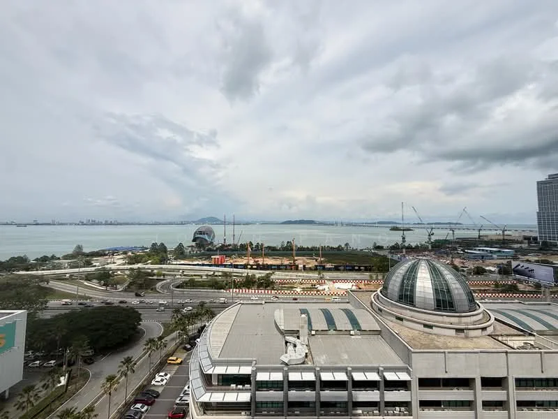Exterior features: waterfront view, city skyline in background, surrounded by greenery, multiple cranes visible, curved glass dome structure, paved road, urban landscape; style: modern.