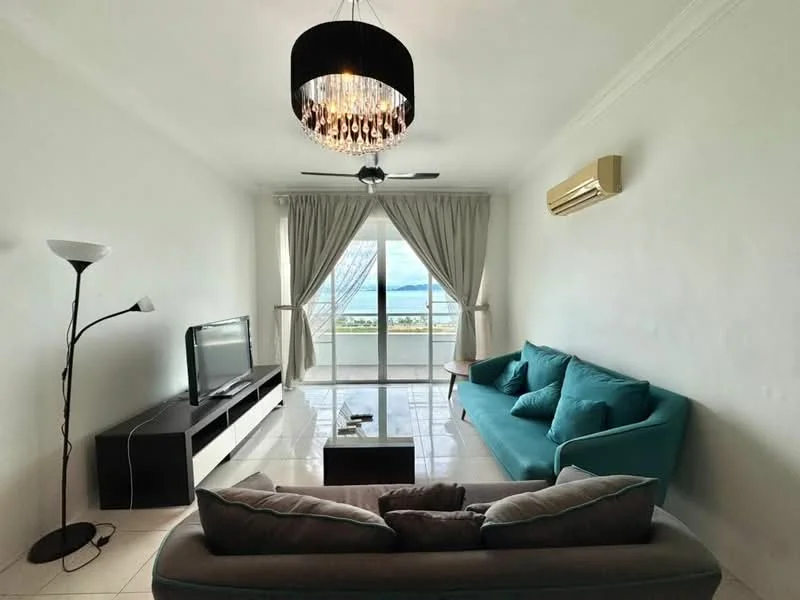 Living features: light grey wall, white ceiling, chandelier light fixture, 5-blade ceiling fan, floor-to-ceiling windows, sliding glass door, light blue fabric sofa, dark grey fabric sofa, black TV console, wall-mounted TV, white tiled flooring, decorative coffee table, lamp with white shade; style: modern; view: sea.