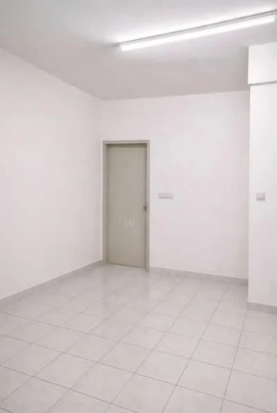 Room features: white painted walls, white ceiling, tile flooring, single door, light fixture on ceiling, no visible furniture, neutral color scheme, spacious layout; style: minimalist.