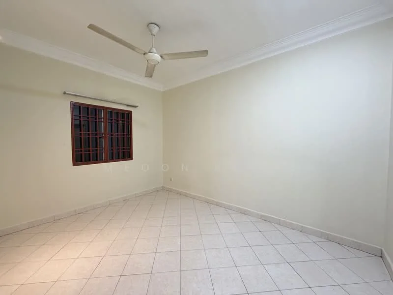 Room features: white painted walls, tile flooring, ceiling fan, single window with grille, corner room, neutral color scheme, no visible furniture, natural light from window.