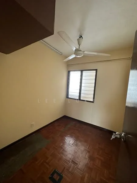 Room features: ceiling fan, single window, wooden flooring, cream painted walls, corner wall, light source from window, door with handle, flooring transition area.