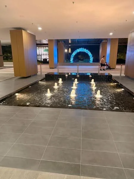 Exterior type: clubhouse; features: water feature with fountain jets, stone-paved walkway, LED lighting, manicured landscaping, seating area, modern architectural design, open space, indoor-outdoor transition; style: modern.