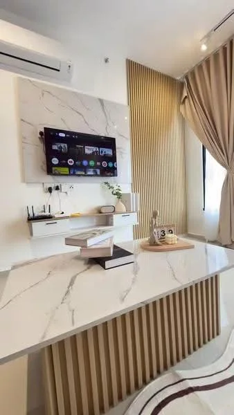 Study features: white marble countertop, wooden desk with vertical slats, wall-mounted TV, air conditioning unit, light-colored walls, curtains in beige, decorative plant, shelves with stationery, area rug with geometric pattern; style: modern.