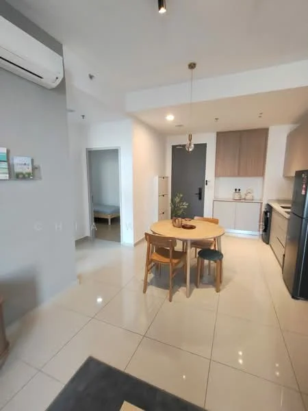 Kitchen features: white painted walls, grey accent wall, glossy tile flooring, recessed downlights, kitchen cabinets in light wood, stainless-steel fridge, built-in countertop, dining table with four chairs, pendant light above dining table, open layout to living area, air conditioning unit on wall; style: modern. Room features: doorway leading to another room, light-colored walls, tile flooring.