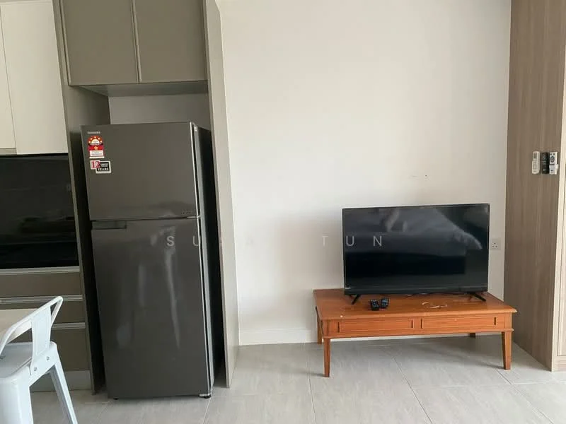 Living features: grey fridge, wall-mounted TV, wooden TV console, light grey tile flooring, white walls, kitchen cabinetry, black countertop, open layout; style: modern.