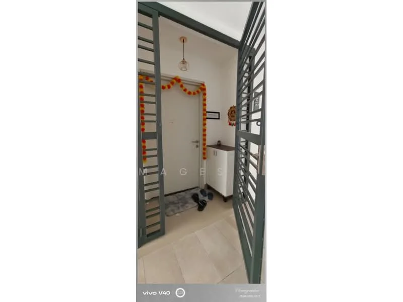 Room features: grey tiled flooring, white walls, metal security door, decorative wall hanging, small console table, decorative items on table, wall-mounted mirror, light fixture with pendant light, exercise weights on floor; style: modern.