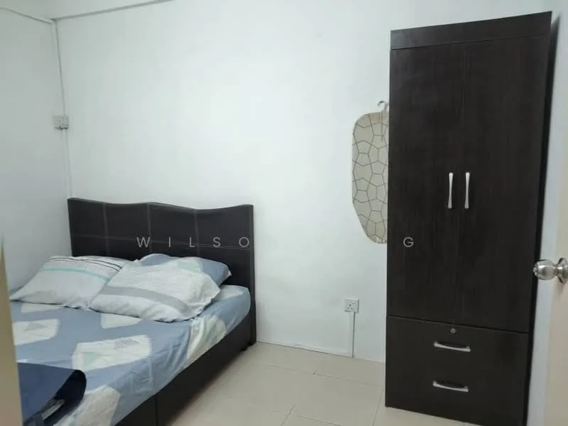 Bedroom features: queen-size bed with upholstered headboard, bedding with patterned duvet and pillows, dark wood wardrobe with two doors and drawers, white painted walls, tile flooring, window with no visible treatment, light fixture on ceiling.