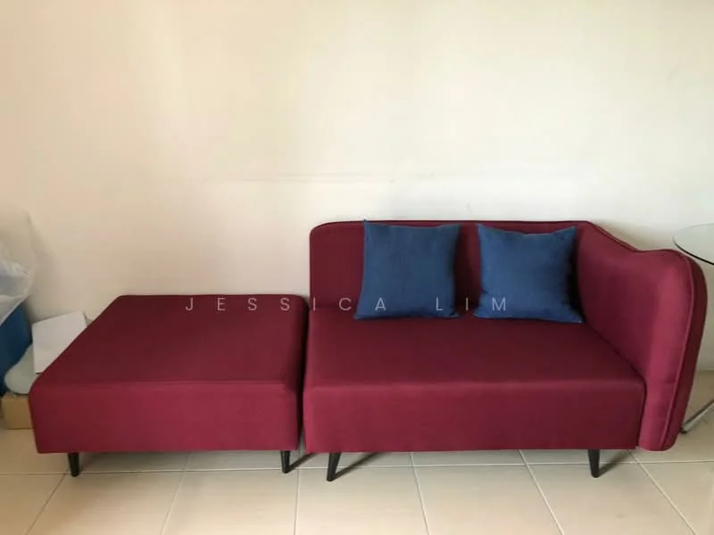 Living features: red fabric sectional sofa, two blue throw pillows, light-colored tiled flooring, plain white walls, glass side table; style: modern.