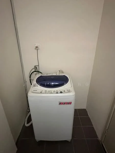Laundry features: top-load washing machine in white, grey tiled flooring, white painted walls, water supply connection, drainage hose.