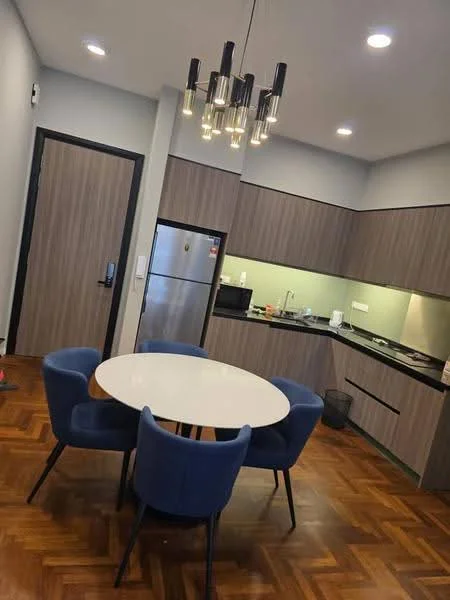 Dining features: round dining table, 4 upholstered dining chairs in blue, pendant light fixture with multiple bulbs, wooden flooring in herringbone pattern, grey cabinetry, black countertop, stainless-steel fridge, built-in microwave, kitchen sink, stove with hood, wall-mounted cabinets, white walls; style: modern. Kitchen features: black countertop, grey cabinetry, stainless-steel fridge, built-in microwave, kitchen sink, stove with hood, wall-mounted cabinets; style: modern.