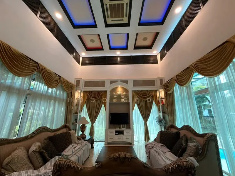 Living features: sofa with ornate wooden frame, upholstered cushions in neutral tones, large floor-to-ceiling windows, sheer curtains, drapes in gold fabric, recessed ceiling lights, tray ceiling with colored panels, wall-mounted TV, decorative wall paneling, ceiling-mounted air conditioning unit, wooden flooring, decorative lamp, coffee table, wall-mounted fan; style: luxury; view: garden.