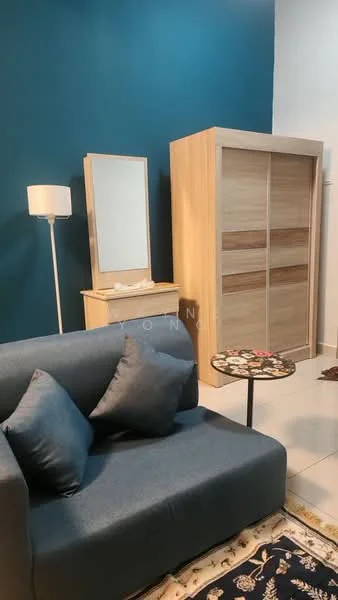 Room features: blue accent wall, light wood wardrobe with sliding doors, light wood dresser with mirror, grey fabric sofa with cushions, small round coffee table, white floor lamp, ceramic floor tiles, decorative area rug; style: modern.