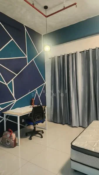 Bedroom features: geometric accent wall in blue and white, grey curtains, white desk, black office chair, single mattress on bed frame, polished tile flooring, ceiling light fixture, exposed ceiling with red piping; style: modern.