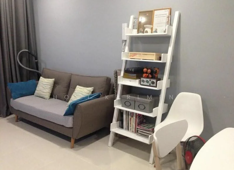 Living features: grey fabric sofa, 2 blue decorative cushions, white ladder shelf, books and decorative items on shelf, white chair, floor lamp, light-colored tiled flooring, grey painted walls, curtains, small fan; style: modern.