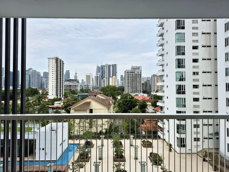 Exterior type: high-rise condominium; features: city skyline view, balcony with railing, surrounding greenery, adjacent low-rise buildings, swimming pool visible in the foreground, modern architectural design, glass facade on nearby buildings, urban landscape, mixed-use environment; style: modern.