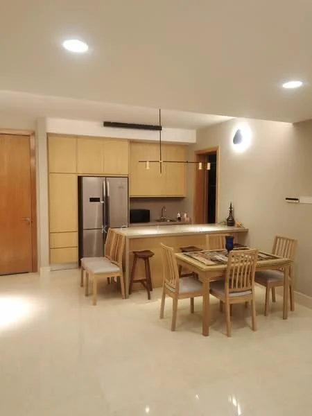 Kitchen features: stainless-steel fridge, built-in cabinetry in light wood, white countertop, single-bowl stainless-steel sink, chrome pull-down faucet, pendant light fixture, recessed downlights, tile backsplash; style: modern. Dining features: 6-seater wooden dining table, wooden dining chairs, decorative table setting, wooden stool, wall-mounted light fixture, cream painted walls, marble flooring; style: modern.