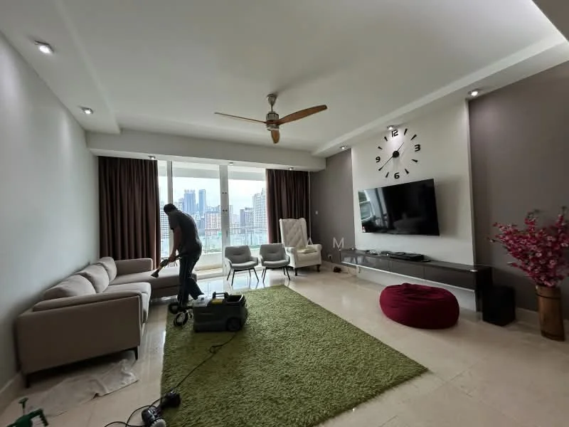 Living features: 3-seater fabric sofa in light grey, 2 white modern chairs, round red ottoman, green area rug, wall-mounted TV, decorative wall clock, ceiling fan with light, floor-to-ceiling windows, curtains in brown, light-colored walls, accent wall in dark grey, recessed downlights; style: modern; view: city.