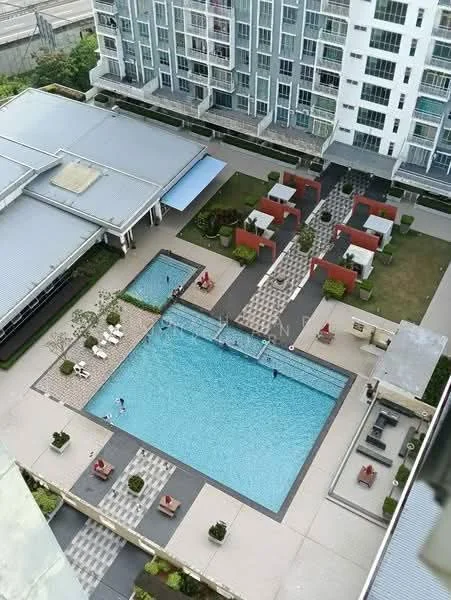 Exterior type: high-rise condominium; features: infinity pool, pool deck with loungers, landscaped garden, manicured lawn, outdoor seating area, paved walkway, children's playground, surrounding greenery; style: modern.