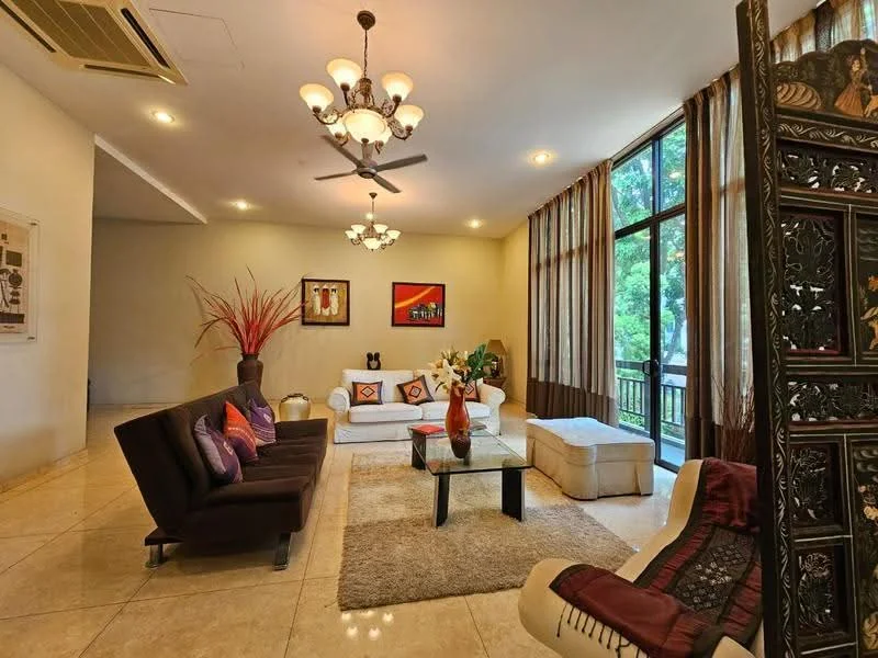 Living features: 3-seater fabric sofa in dark brown, 2-seater fabric sofa in white, coffee table with black glass top, area rug with neutral color, chandelier with multiple bulbs, 5-blade ceiling fan with light, floor-to-ceiling windows, curtains with floral pattern, decorative wall art, vase with decorative branches, potted plants, wall-mounted artwork, wooden partition screen; style: contemporary; view: garden.