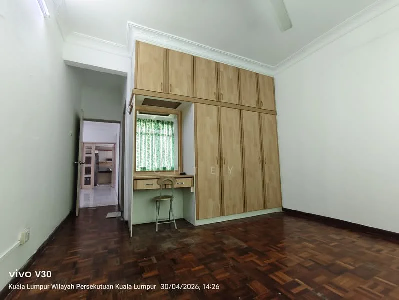 Bedroom features: wooden flooring, white painted walls, crown moulding, built-in wardrobe with wood finish, study desk with chair, window with sheer curtains, ceiling fan, doorway leading to another room; style: minimalist.