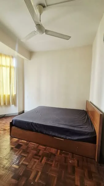Bedroom features: queen-size bed, wooden bed frame, parquet wood flooring, 5-blade ceiling fan, yellow sheer curtains, white painted walls, window with natural light.