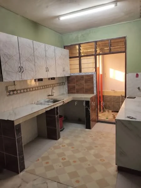 Kitchen features: white marble countertop, grey patterned cabinetry, single-bowl stainless-steel sink, chrome faucet, tile backsplash with decorative border, floor tiles in cream and brown pattern, window with metal grille, door leading to outdoor area, light fixture on ceiling, built-in cabinets, open shelving, space for appliances; style: modern.