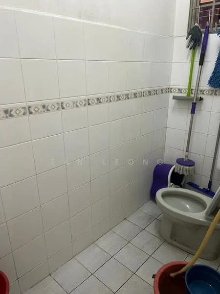 Bathroom features: white tiled walls, grey tiled flooring, one-piece toilet, mop, cleaning supplies, toilet brush, bucket, wall-mounted cleaning tool holder.