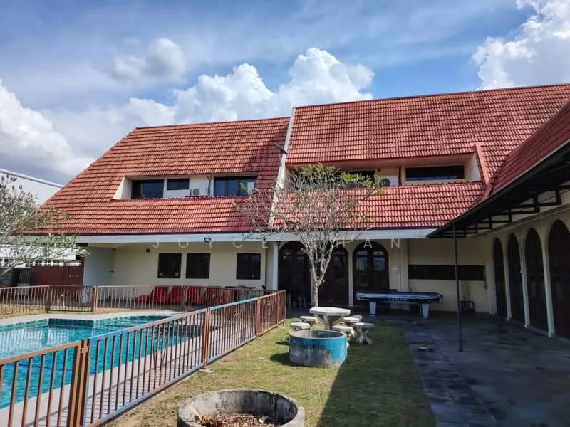 Exterior type: detached bungalow; features: red pitched tile roof, white painted facade, swimming pool, pool deck with loungers, manicured lawn, mature trees, outdoor seating area with chairs, stone-paved walkway, arched windows, double doors at entrance; style: traditional.