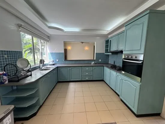 Kitchen features: light blue cabinetry, black countertop, built-in oven, 4-burner gas hob, double-bowl stainless-steel sink, chrome pull-down faucet, tile backsplash in blue, window with view of greenery, ceiling with recessed lighting, open shelving, cream tile flooring; style: modern; view: garden.