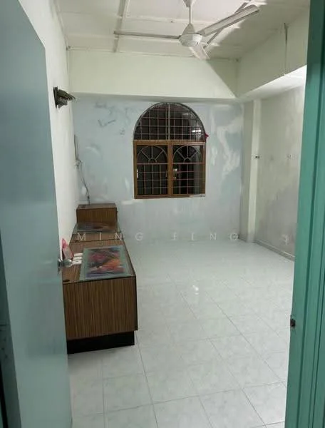 Room features: white painted walls, ceramic tile flooring, ceiling fan, arched window with metal grille, wooden sideboard, light-colored door, neutral color scheme; style: minimalist.