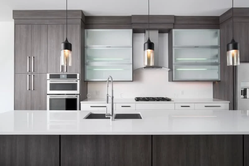 Kitchen features: dark wood cabinetry, white quartz countertop, single-bowl stainless-steel sink, chrome pull-down faucet, built-in oven, stainless-steel range hood, 5-burner gas hob, glass-front upper cabinets, pendant lighting, recessed downlights, open shelving, modern design; style: modern.