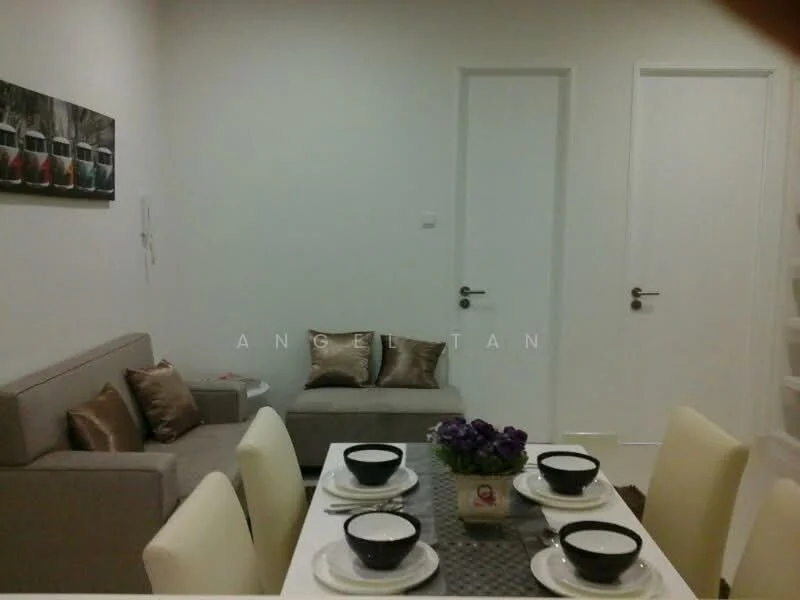 Living features: light grey fabric sofa, decorative cushions in gold, white painted walls, recessed lighting, wooden flooring, framed artwork on wall, small side table, floor-to-ceiling door, white door, decorative plants; style: modern. Dining features: white dining table, 4 upholstered dining chairs, black bowls on table, grey table runner, decorative flowers in vase; style: modern.