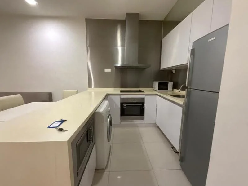 Kitchen features: white cabinetry, marble countertop, stainless-steel sink, chrome pull-down faucet, built-in oven, freestanding range oven, microwave, stainless-steel fridge, washer-dryer combo, ceramic tile flooring, recessed downlights, grey accent wall; style: modern.