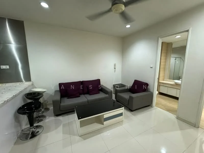 Living features: grey fabric sofa, 2 purple throw pillows, black coffee table with white accents, 2 black bar stools, marble countertop, white tiled flooring, ceiling fan, wall-mounted intercom, light-colored walls, doorway leading to bathroom, natural light from doorway; style: modern.
