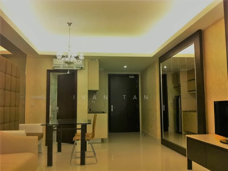 Living features: cream painted walls, glossy tile flooring, recessed ceiling lights, chandelier, wall-mounted mirror, TV console, dining table with chairs, air conditioning unit; style: modern. Room features: wooden door, kitchen area visible in background.