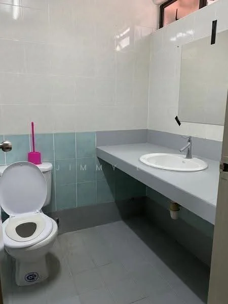 Bathroom features: white ceramic toilet, single-sink vanity with grey countertop, chrome basin mixer faucet, mirror above sink, light grey wall tiles, light blue wall tiles, grey floor tiles, pink toilet brush holder.