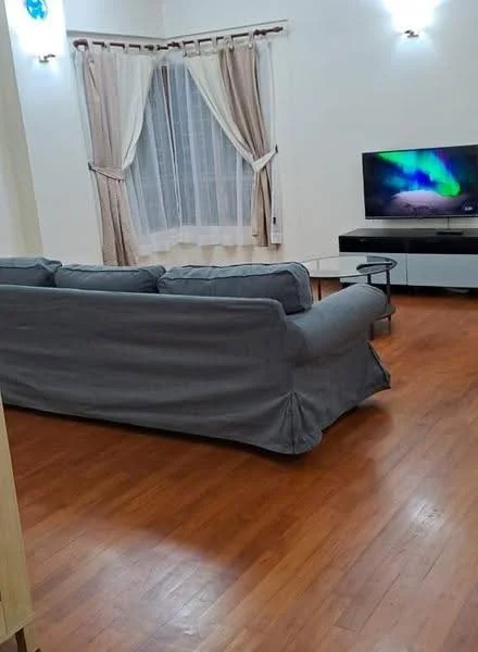 Living features: 3-seater fabric sofa in grey, wooden flooring, TV console, wall-mounted TV, curtains with sheer and blackout layers, recessed downlights, decorative wall sconce, coffee table, large window with white sheer curtains; style: modern.