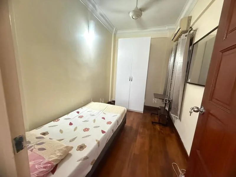 Bedroom features: single bed with floral bedding, wooden flooring, white painted walls, ceiling fan, built-in wardrobe with sliding doors, study desk, wall-mounted mirror, window with blinds.