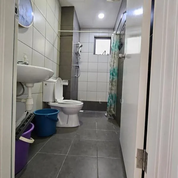 Bathroom features: white tiled walls, grey tiled flooring, single-sink vanity with white cabinet, chrome basin mixer faucet, one-piece toilet, walk-in shower with glass enclosure, shower head, mirror above sink, towel rack, two plastic bins in purple and blue; style: modern.