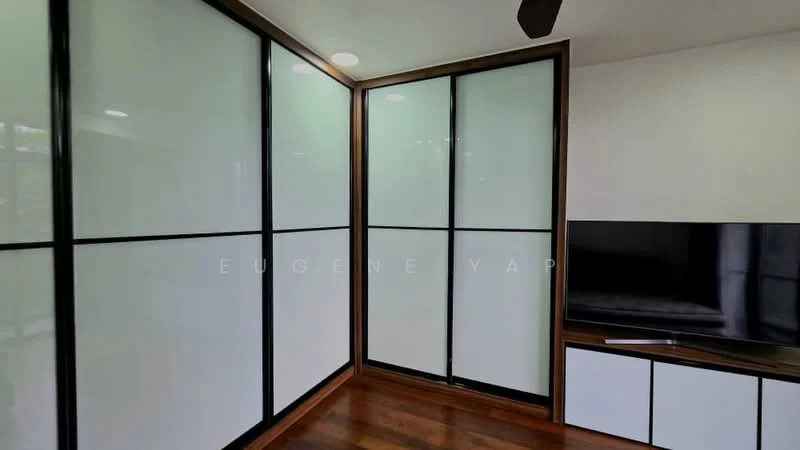 Room features: sliding glass doors with black frames, wooden flooring, white wall panels, dark wood trim, wall-mounted TV, TV console with white cabinetry, ceiling fan, recessed lighting; style: modern.
