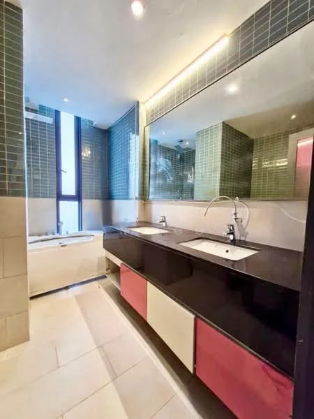 Bathroom features: double-sink vanity with black countertop, chrome basin mixers, large framed mirror, bathtub, green mosaic tile walls, cream tiled flooring, floor-to-ceiling window, recessed lighting; style: modern.