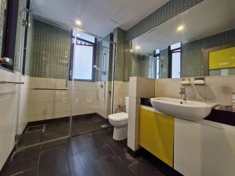 Bathroom features: glass shower enclosure, chrome shower head, white wall-mounted sink, yellow cabinetry, white toilet, black tile flooring, green mosaic tile walls, large mirror, window for natural light; style: modern.