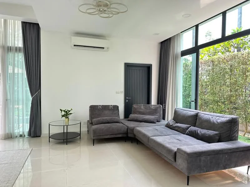 Living features: grey fabric sectional sofa, glass coffee table, floor-to-ceiling windows, white painted walls, cream tiled flooring, 1 wall-mounted split AC, sheer curtains, dark wood door, greenery view from windows; style: modern; view: garden.